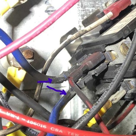 plastic coated wires in red, blue, and gray twist through mechanical housing
