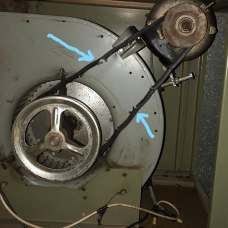 dark thin flexible cable mounted onto two metal wheels on either end